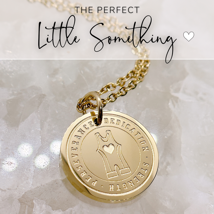 Thhat perfect little something, godl wrestling disc charm necklace.