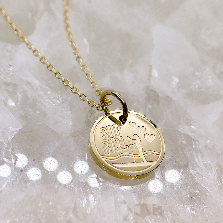 Gold stand up paddleboard disc charm necklace.