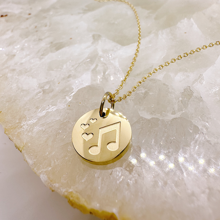 Gold music note disc charm necklace.