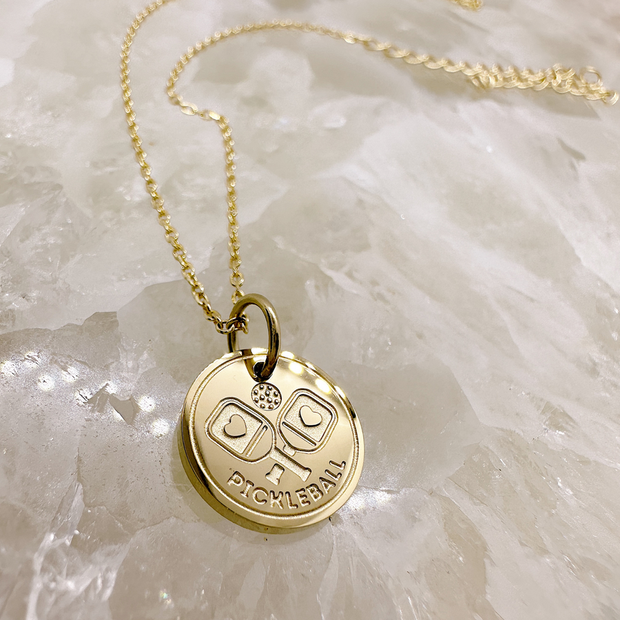 Gold pickleball disccharm necklace.