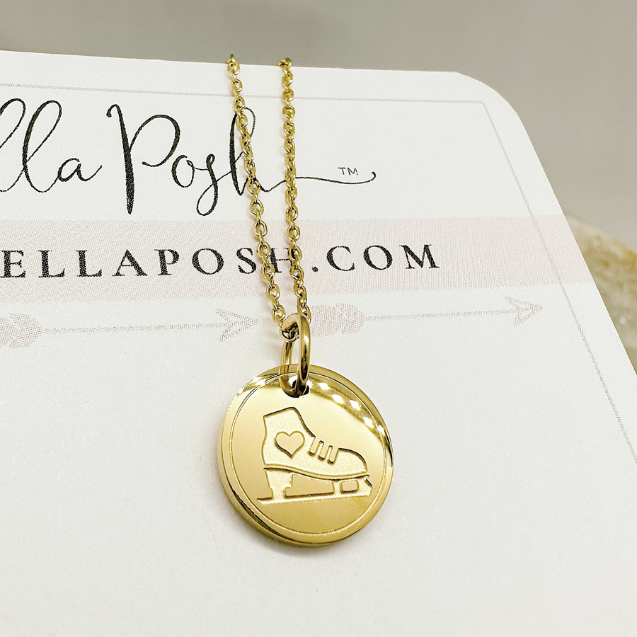 Gold ice skate disc charm necklace.
