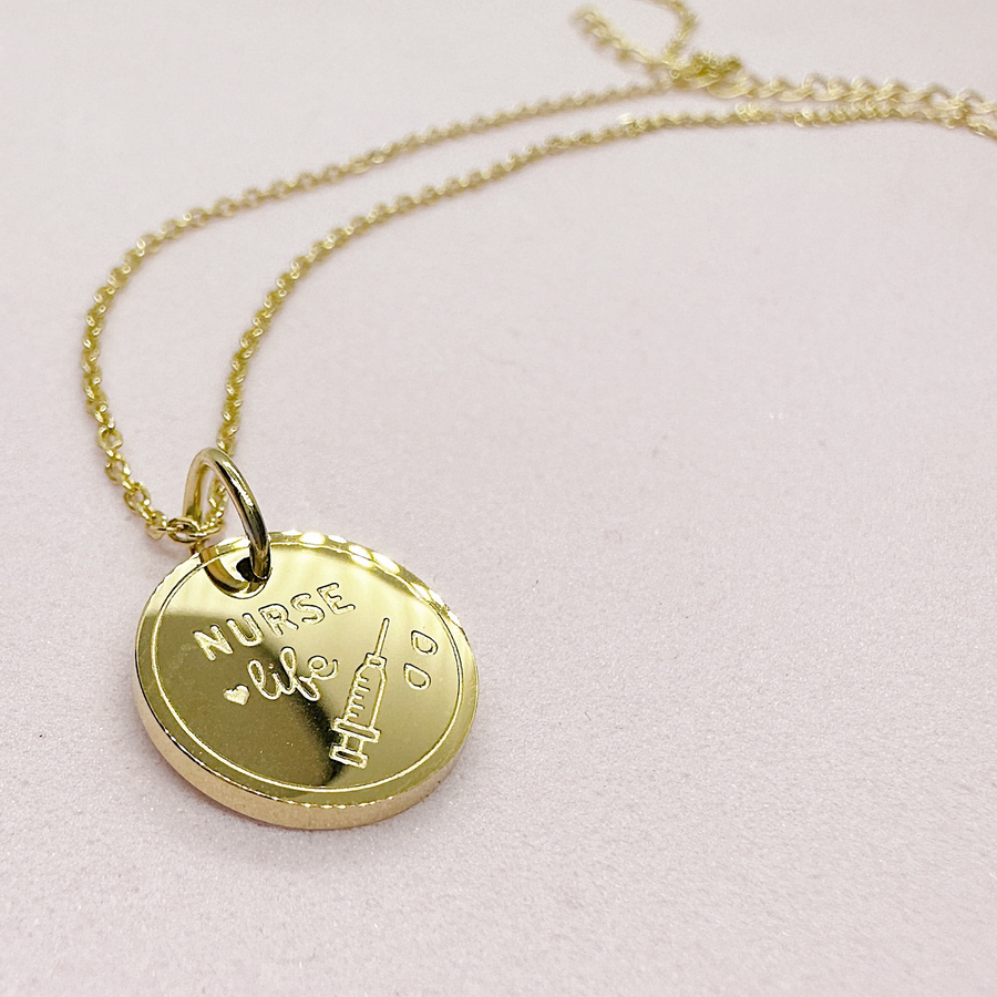 Gold nurse disc charm necklace.