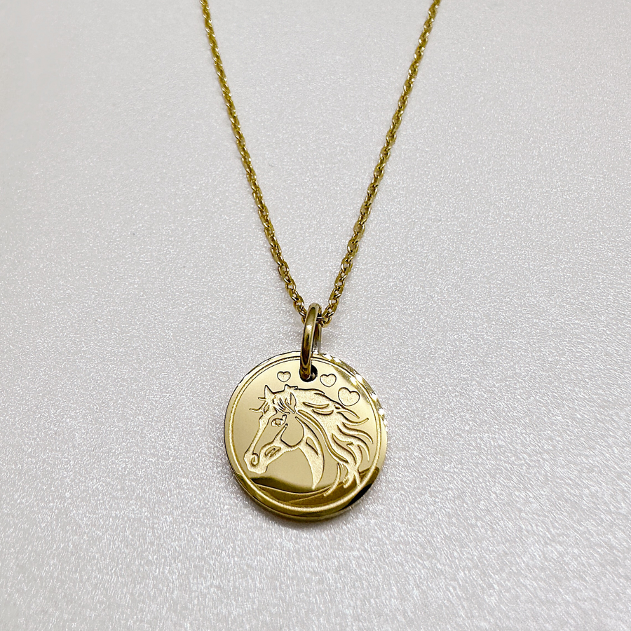 Equestrian disc charm necklace in gold.