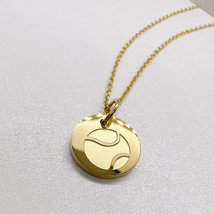 Gold tennis disc charm necklace.