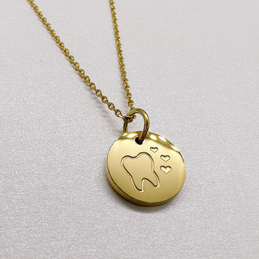 Gold tooth disc charm necklace.