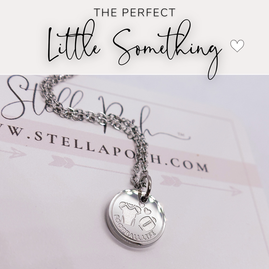 That perfect little something, silver football disc charm necklace.