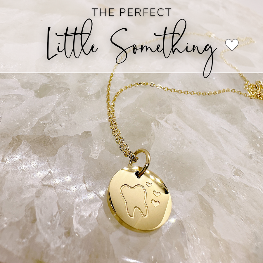 That perfect little something, gold tooth disc charm necklace.