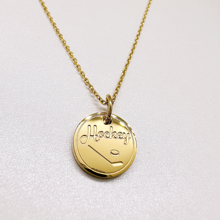 Gold hockey disc charm necklace.