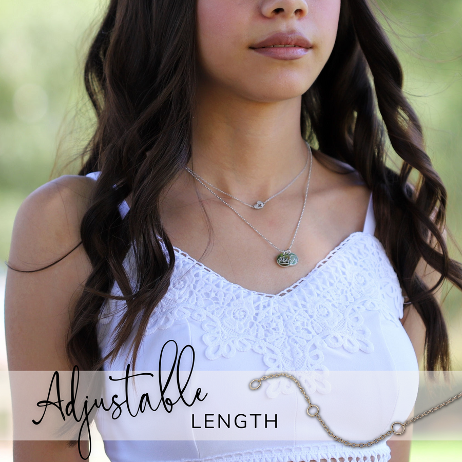 Brunette Teen Model wearing Tiny .925 silver Nurse Necklace with premium cubic zirconias, layered with a Charm Necklace.